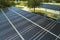 Aerial view of solar panels installed as shade roof over parking lot for parked cars for effective generation of clean