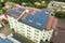 Aerial view of solar power plant with blue photovoltaic panels mounted of apartment building roof