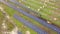 Aerial view of solar power plant under construction on green field. Assembling of electric panels for producing clean