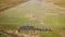 Aerial view of solar power plant under construction on green field. Assembling of electric panels for producing clean