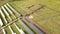 Aerial view of solar power plant under construction on green field. Assembling of electric panels for producing clean ecologic ene