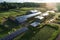 aerial view of a solar-powered factory with green surroundings