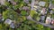 Aerial view of some large detached houses set amongst woodland