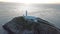 Aerial view of South Stack with lighthouse and cliffs during sunset