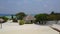 Aerial view of spa bungalow on tropical island resort hotel with white sand beach, palm trees and turquoise Indian ocean