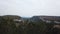 Aerial View: a span in the middle of a canyon, on one side of the cliff, on the other side of the forest. In the middle