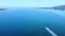 Aerial view of speedboat sailing on blue turquoise sea. Speedboat sailing towards narrow passage between island and coast