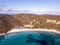 Aerial view of Spiaggia Bianca, White Beach in Golfo Aranci, blue water, amazing granite rocks and sandy beach