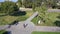 Aerial view of a sportive girl on roller skates. Driving on asphalt in a green park. Fitness. Side view.