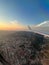 Aerial view of a sprawling modern from an airplane window city at sunset