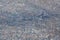 Aerial view of stack of different types of large mountain garbage pile, plastic bags, and trash with a tractor car in industrial