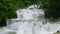 Aerial view of stair like rock formations in Aliwagwag Falls. Slow motion.