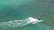 Aerial view, Stand up paddle SUP surfer riding wave off the coast of Thailand, in deep blue water, slow motion _