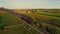 Aerial View on a Steam Engine and Passenger Coaches Approaching Blowing Smoke and Steam Following Train From in Front