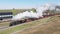 Aerial View of a Steam Passenger Train Slowly Traveling Thru an Amusement Park