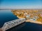 Aerial view of steel or metal railroad bridge over big blue river