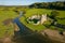 Aerial view of stepping stones over a small river leading to the ruins of an ancient castle Ogmore Castle, Wales