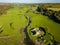 Aerial view of stepping stones over a small river leading to the ruins of an ancient castle Ogmore Castle, Wales