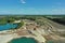 Aerial view of the storage area of a sand mining site with sand heaps, gravel heaps and machines for mining