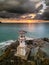 Aerial view of a stormy, tropical sunset behind a lighthouse (Khao Lak, Thailand