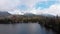 Aerial view of Strbske Pleso, Slovakia. Mountain Lake in Clouds and Snowy Tatras Mountains