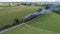 Aerial View of a Streamlined Steam Locomotive Traveling Around a Curve, Blowing Lots of Smoke