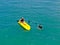 Aerial view of strong young active men capsizing with their kayak