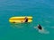 Aerial view of strong young active men capsizing with their kayak