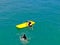 Aerial view of strong young active men capsizing with their kayak