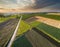 Aerial view of stunning agricultural fields showcasing nature\\\'s geometric patterns at sunset