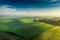 Aerial view of stunning foggy wind turbine at sunrise