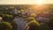 Aerial View of Suburban Neighborhood at Sunset with Glowing Homes