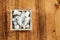 Aerial View of Sugar Cubes in Square Shaped Bowl with Unrefined Sugar spill over in Wooden Background