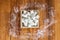 Aerial View of Sugar Cubes in Square Shaped Bowl with Unrefined Sugar spill over in Wooden Background.