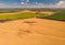 Aerial view of summer harvest. Combine harvester harvesting large field