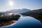 Aerial view of the sun rising above Fort William and the Ben Nevis mountain range in the Scottish Highlands