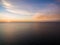 Aerial view of sun setting over ocean. Nothing but skies and water. Beautifu scene.