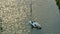 Aerial view of sunken sailboat on shallow bay waters after hurricane Ian in Manasota, Florida