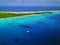 Aerial view of a sunken WWII ship wreck with an anchored yacht and beautiful island/sea back scene