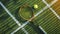 An Aerial View of a Sunlit Tennis Court, Complete with a Racket and Yellow Ball