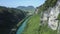 Aerial view sunny canyon river bank with green grass