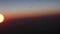 Aerial view of sunrise through airliner window in the morning. Aerial view of Cloudscape in dawn through plane window