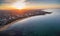 Aerial view of sunrise at Brighton Beach showing the suburb and