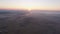 Aerial view of sunset above foggy riverside