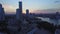 Aerial view of sunset above the skyscrapers and other buildings. Stock footage. Late evening in a sunny modern city