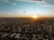 Aerial view of sunset in Neuquen city with sun falling down in the skyline