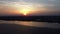 Aerial view of sunset over the river covered by ice at a spring evening