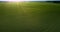 Aerial view sunset rays light boundless green field
