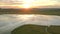 Aerial view of the sunset touring a lake and an oak. Extremadura. Spain