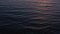 Aerial view of surface of the Atlantic Ocean with reflection of sunlight at sunset